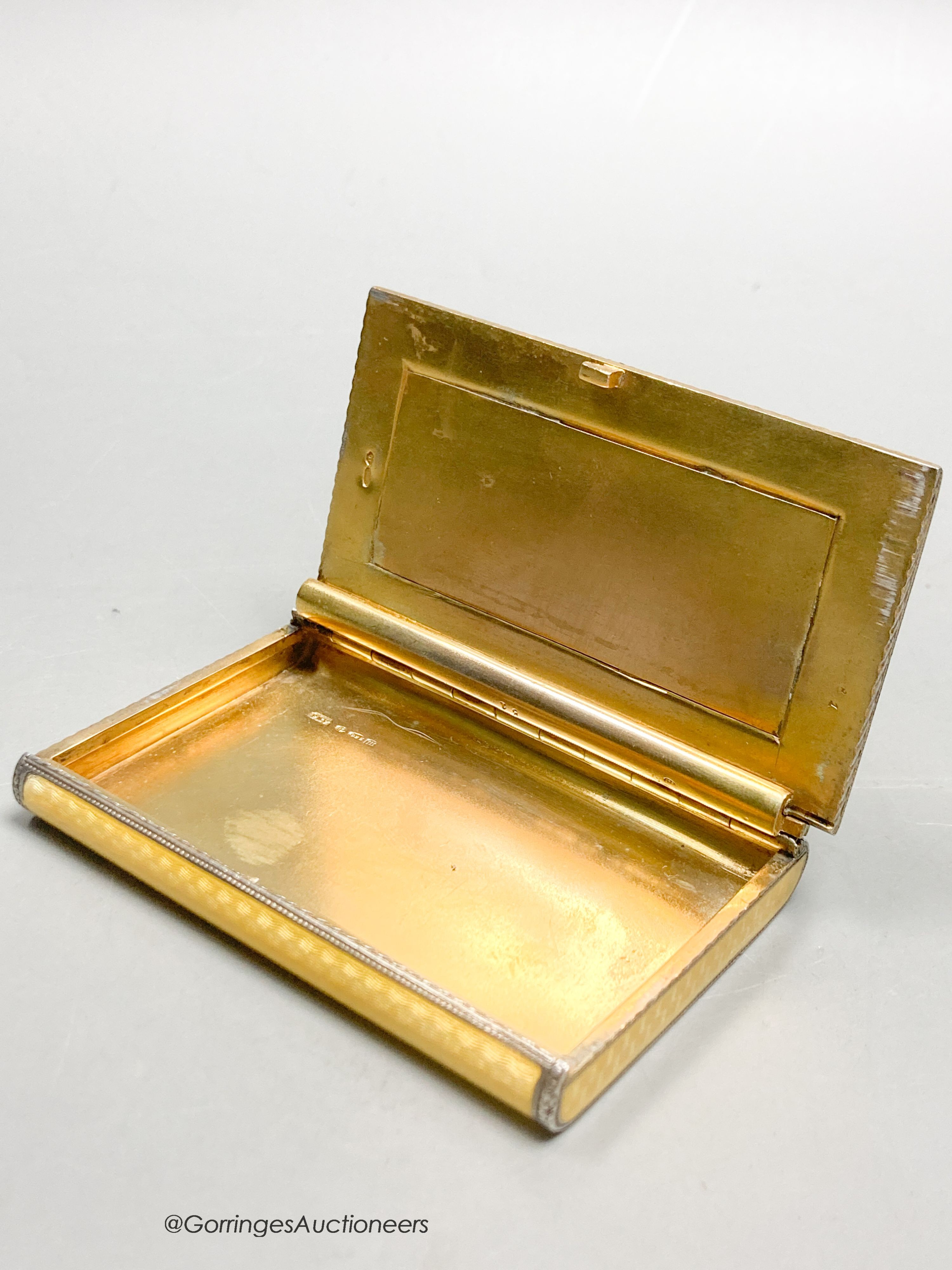 A 1920's continental silver and yellow guilloche enamel rectangular box and hinged cover, import marks for P.H. Vogel & Co, London, 1927, 79mm by 53mm by 10mm